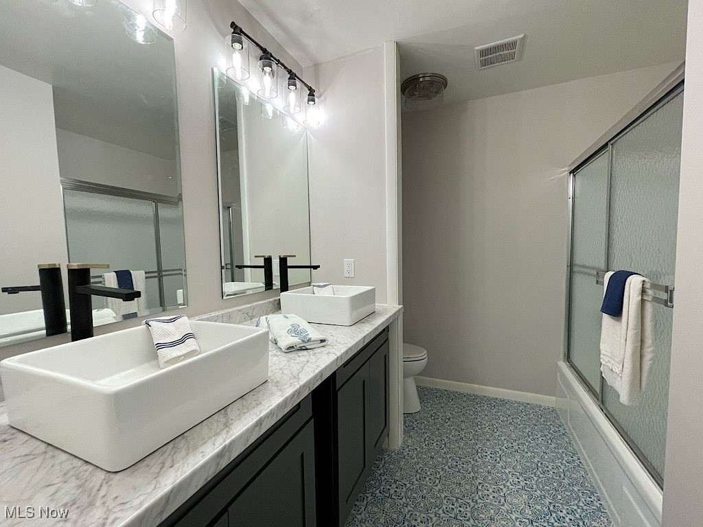2285 Killian Road Akron, OH 44312 - Photo 7 of 32 Full bathroom featuring shower / bath combination with glass door, vanity, and toilet