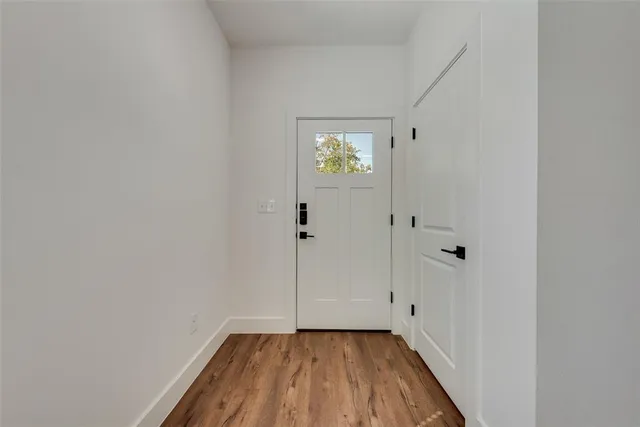 a view of a hallway with wooden floor