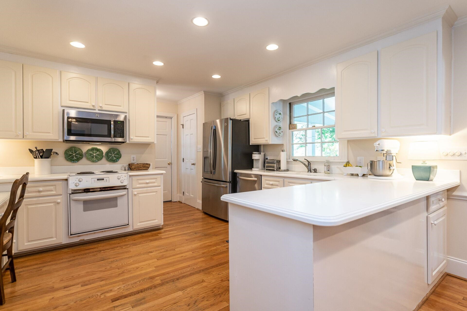 2834 Exeter Circle Raleigh, NC 27608 - Photo 10 of 30 a kitchen with kitchen island granite countertop a sink stove and refrigerator