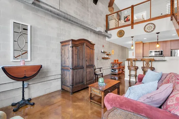 a living room with furniture a rug and a chandelier