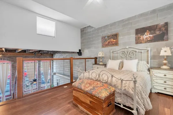 a bedroom with furniture and wooden floor