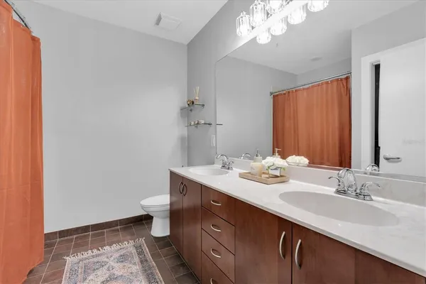 a bathroom with a sink a toilet and a mirror