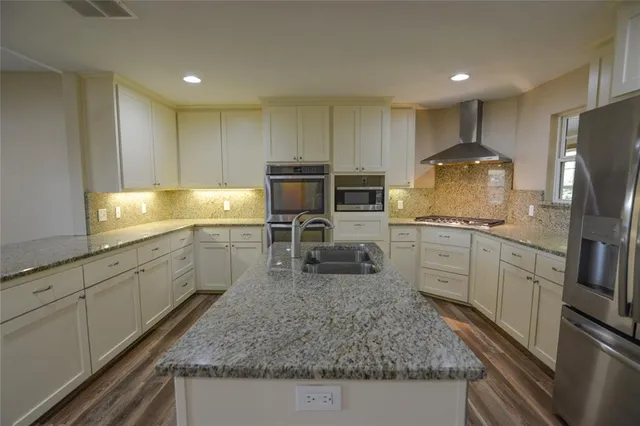 a kitchen with a sink microwave and refrigerator