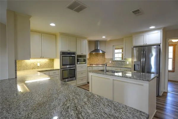 a kitchen with a sink stainless steel appliances and cabinets