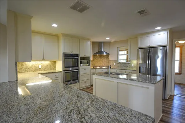 a kitchen with a sink stainless steel appliances and cabinets