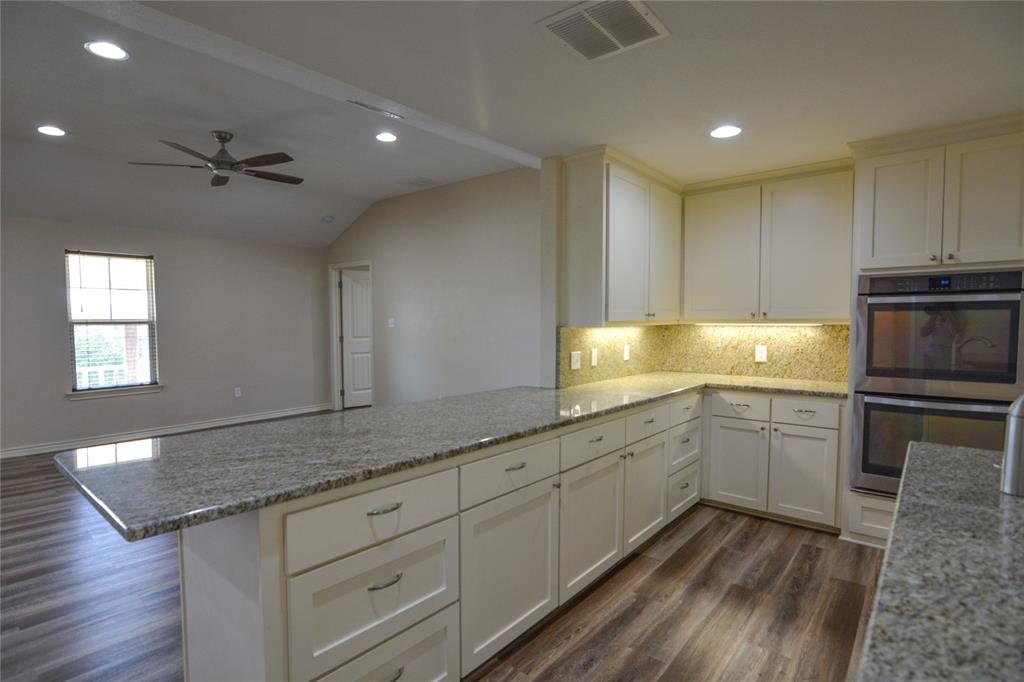 322 Hcr 2320 Abbott, TX 76621 - Photo 18 of 40 a kitchen with granite countertop cabinets stainless steel appliances a sink and wooden floor