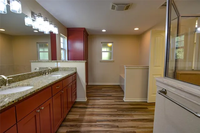 a bathroom with sink shower and a mirror