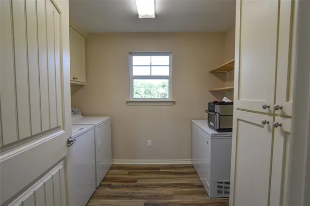a view of a hallway with a white cabinet and a window