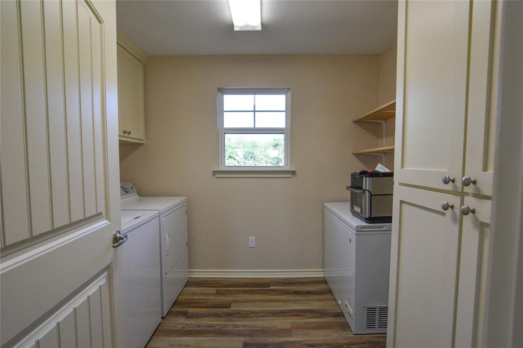 322 Hcr 2320 Abbott, TX 76621 - Photo 29 of 40 a view of a hallway with a white cabinet and a window
