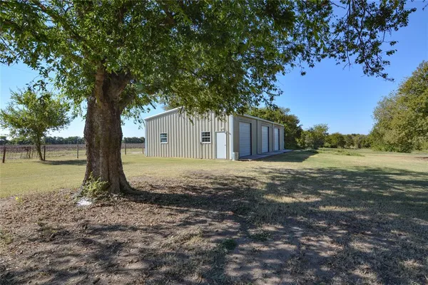 a view of a backyard with large trees