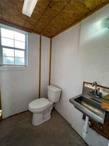 a bathroom with a toilet and a mirror