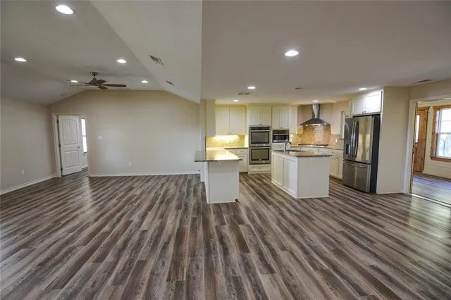 a view of a kitchen with wooden floor