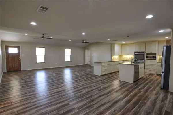a view of a kitchen with a sink and a large window