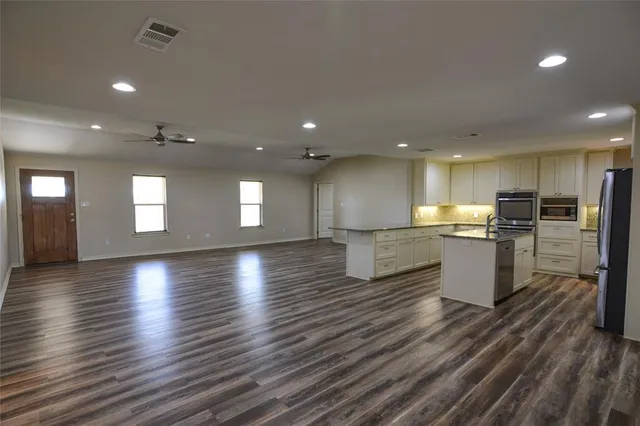 a view of a kitchen with a sink and a large window
