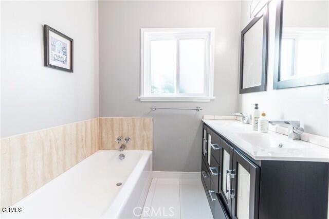412 South Kenneth Road Burbank, CA 91501 - Photo 14 of 24 a bathroom with a tub a sink and a window