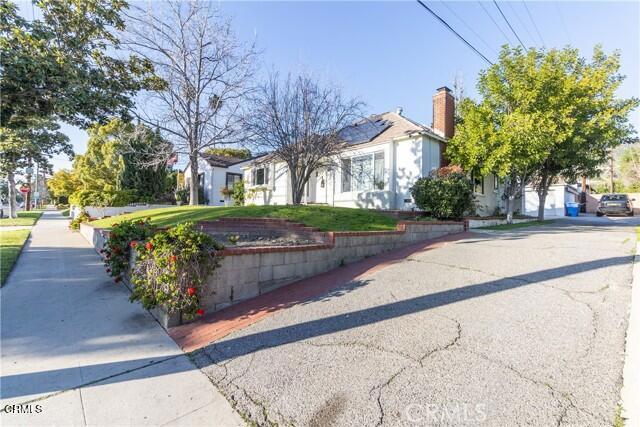412 South Kenneth Road Burbank, CA 91501 - Photo 22 of 24 a front view of a house with a yard and garage
