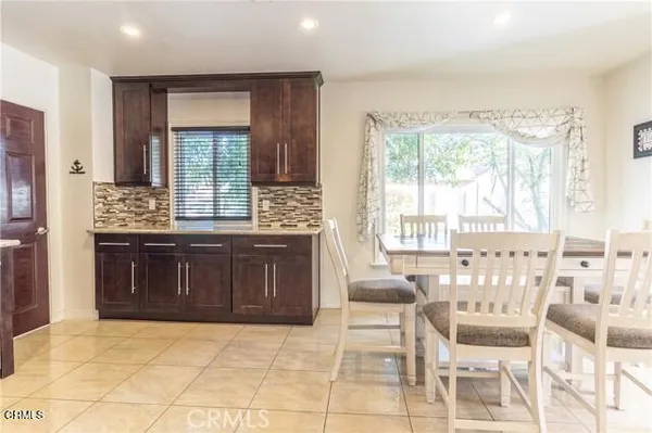 a spacious bathroom with a granite countertop sink and a bathtub