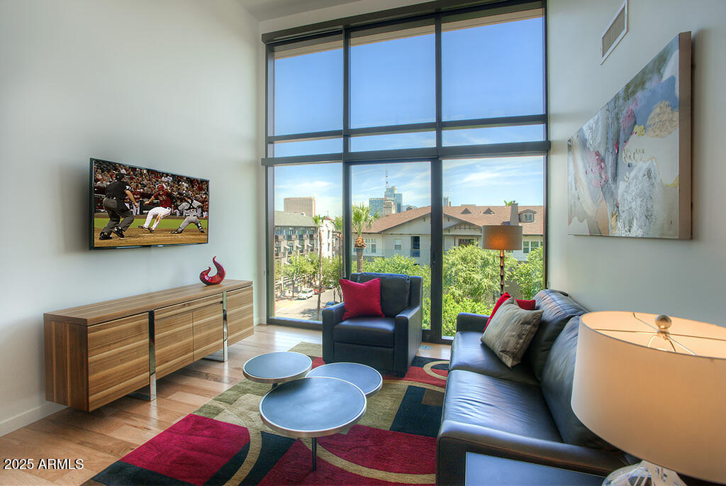 100 West Portland Street, Unit 506 Phoenix, AZ 85003 - Photo 1 of 25 a living room with furniture cabinets and a large window
