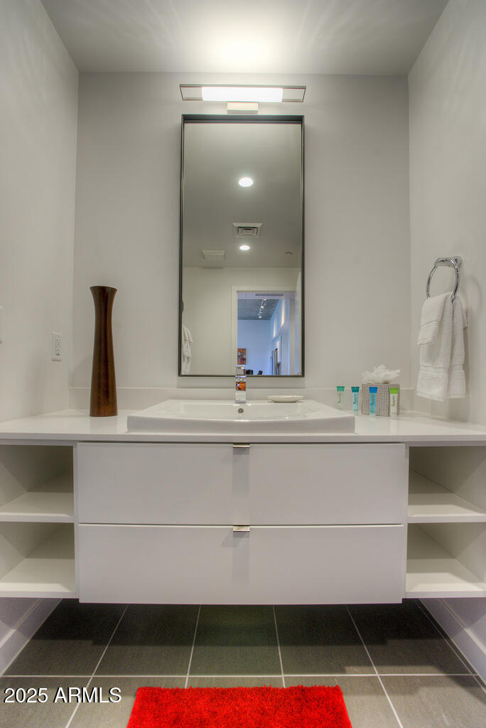 100 West Portland Street, Unit 506 Phoenix, AZ 85003 - Photo 12 of 25 a bathroom with a sink and a mirror