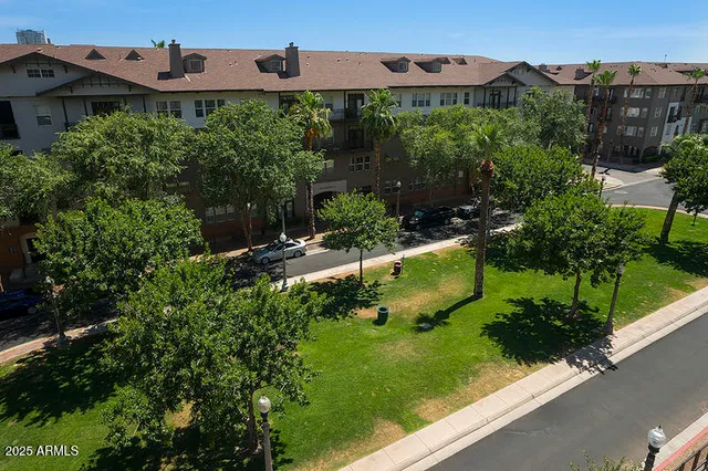 an aerial view of a house with a garden and large trees