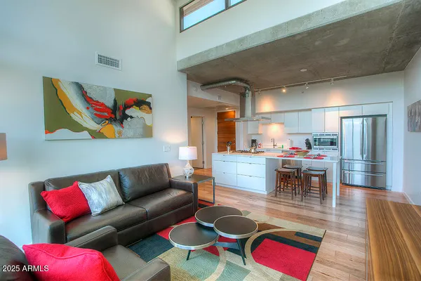 a living room with furniture kitchen view and a dining table