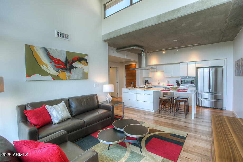 100 West Portland Street, Unit 506 Phoenix, AZ 85003 - Photo 2 of 25 a living room with furniture kitchen view and a dining table