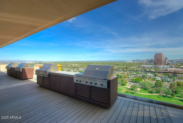 a view of a roof deck with wooden floor and fence