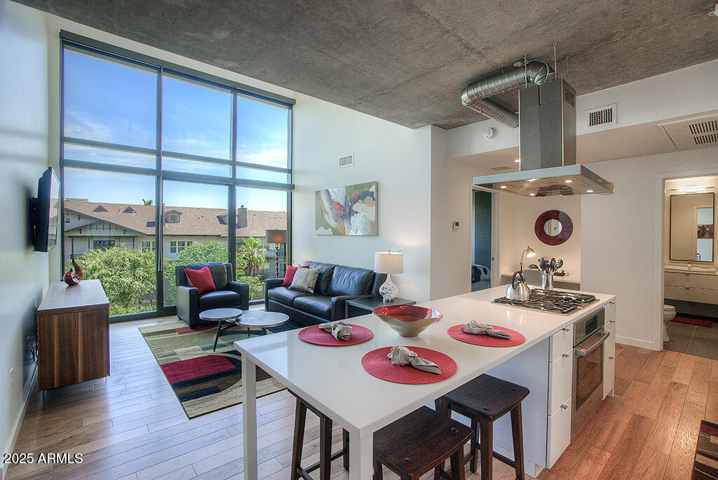100 West Portland Street, Unit 506 Phoenix, AZ 85003 - Photo 3 of 25 a view of a dining room with furniture window and wooden floor