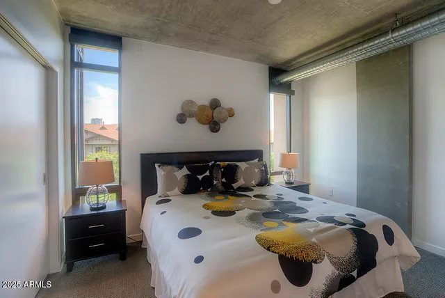 a bed sitting in a bedroom next to a window