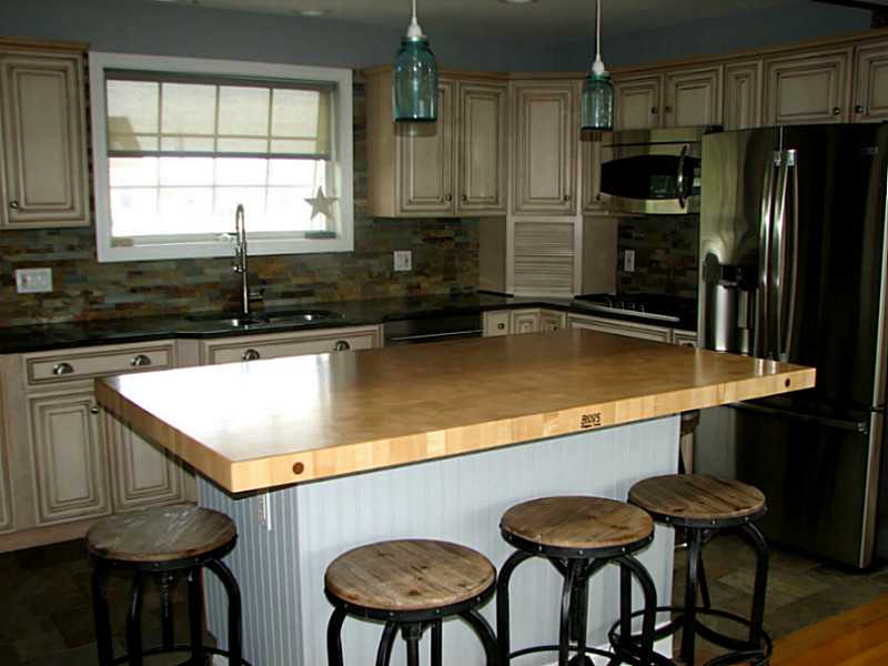 3 Tellier Road Narragansett, RI 02882 - Photo 3 of 25 Kitchen. Granite, Stone back splash, custom cabinetry. Butcher block breakfast bar/island
