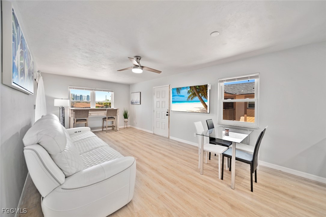 16881 Davis Road, Unit 721 Fort Myers, FL 33908 - Photo 2 of 23 a living room with furniture and a wooden floor