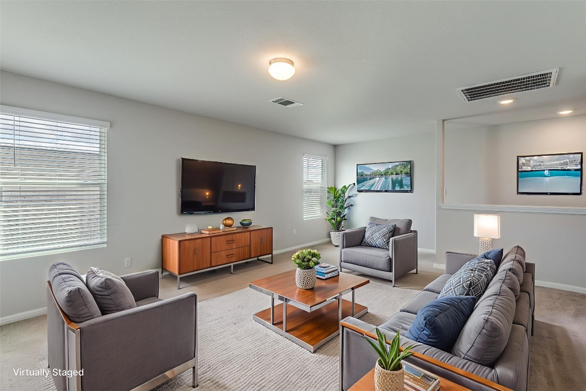 12912 Cerro Castellan Trace Manor, TX 78653 - Photo 13 of 36 a living room with furniture and a flat screen tv