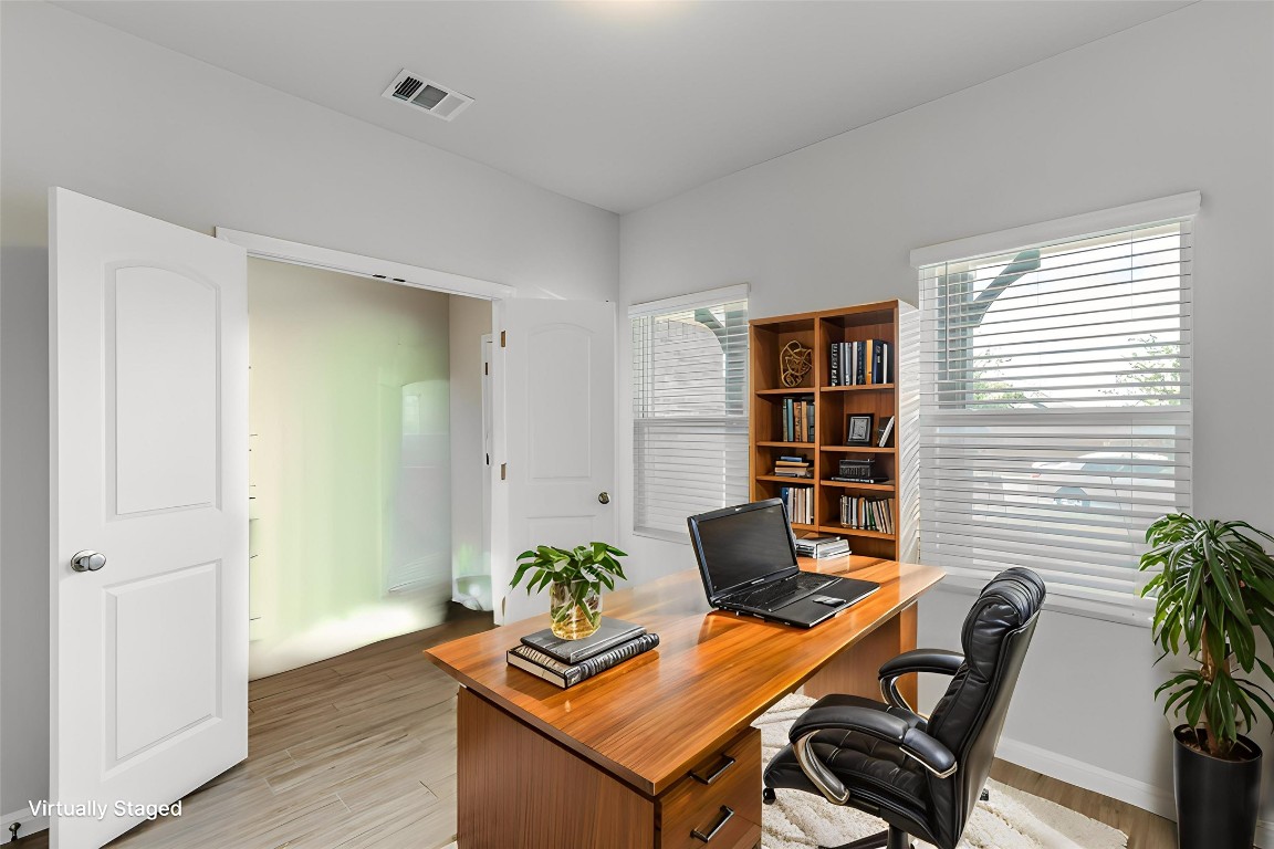 12912 Cerro Castellan Trace Manor, TX 78653 - Photo 15 of 36 a view of a workspace with furniture and wooden floor