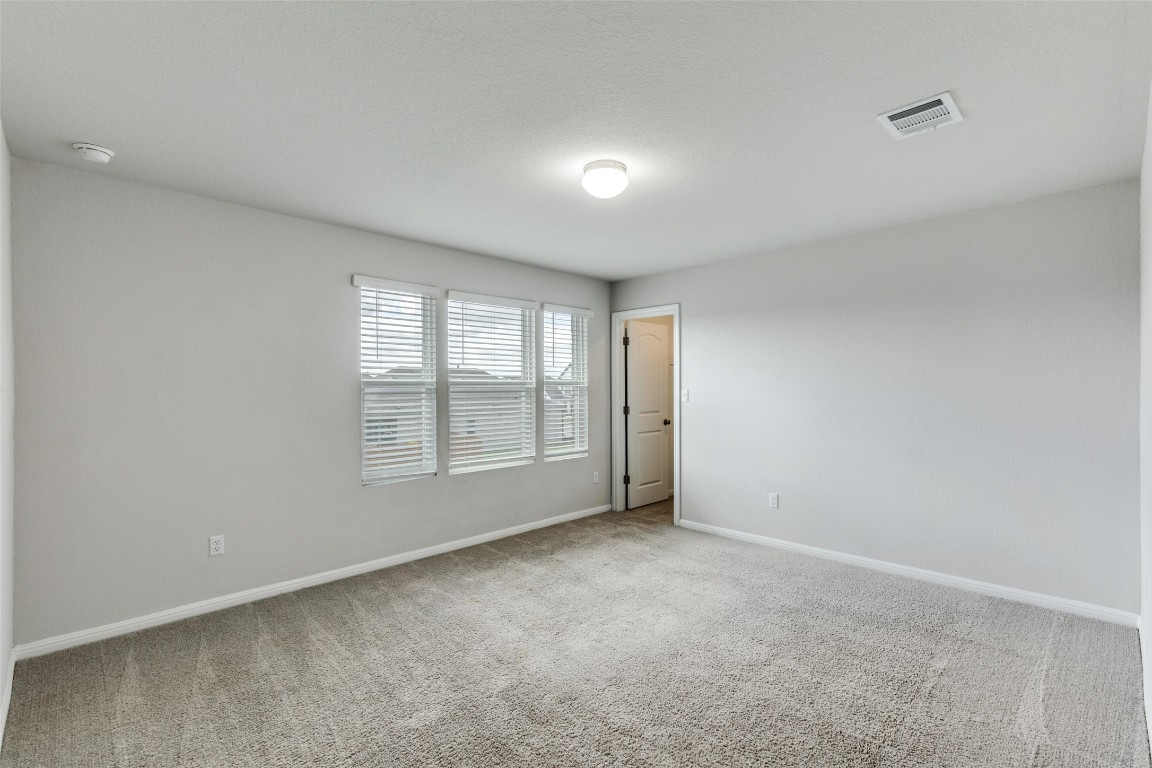12912 Cerro Castellan Trace Manor, TX 78653 - Photo 18 of 36 a view of an empty room with a window