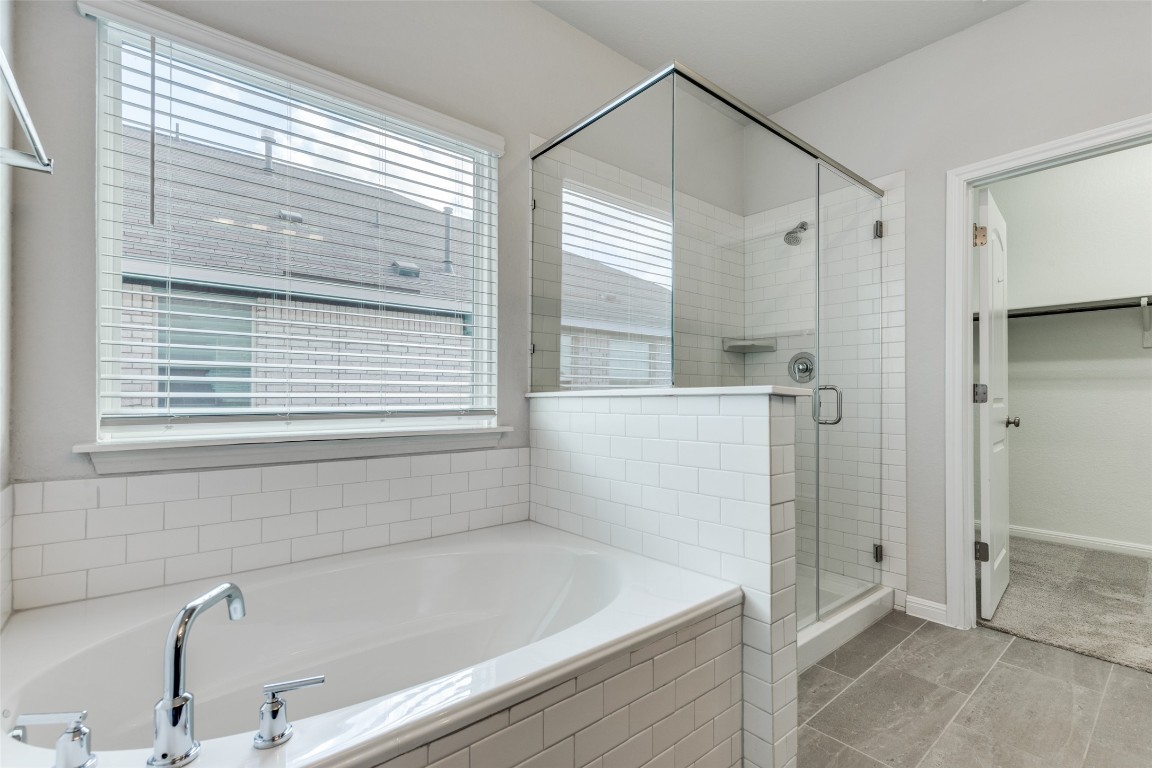 12912 Cerro Castellan Trace Manor, TX 78653 - Photo 20 of 36 a bathroom with a shower and a bathtub