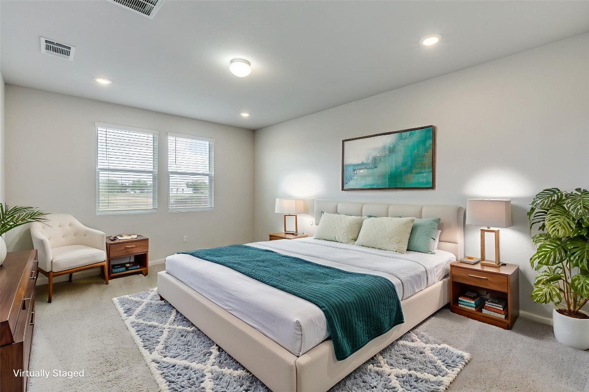 12912 Cerro Castellan Trace Manor, TX 78653 - Photo 21 of 36 a bedroom with a bed and a window