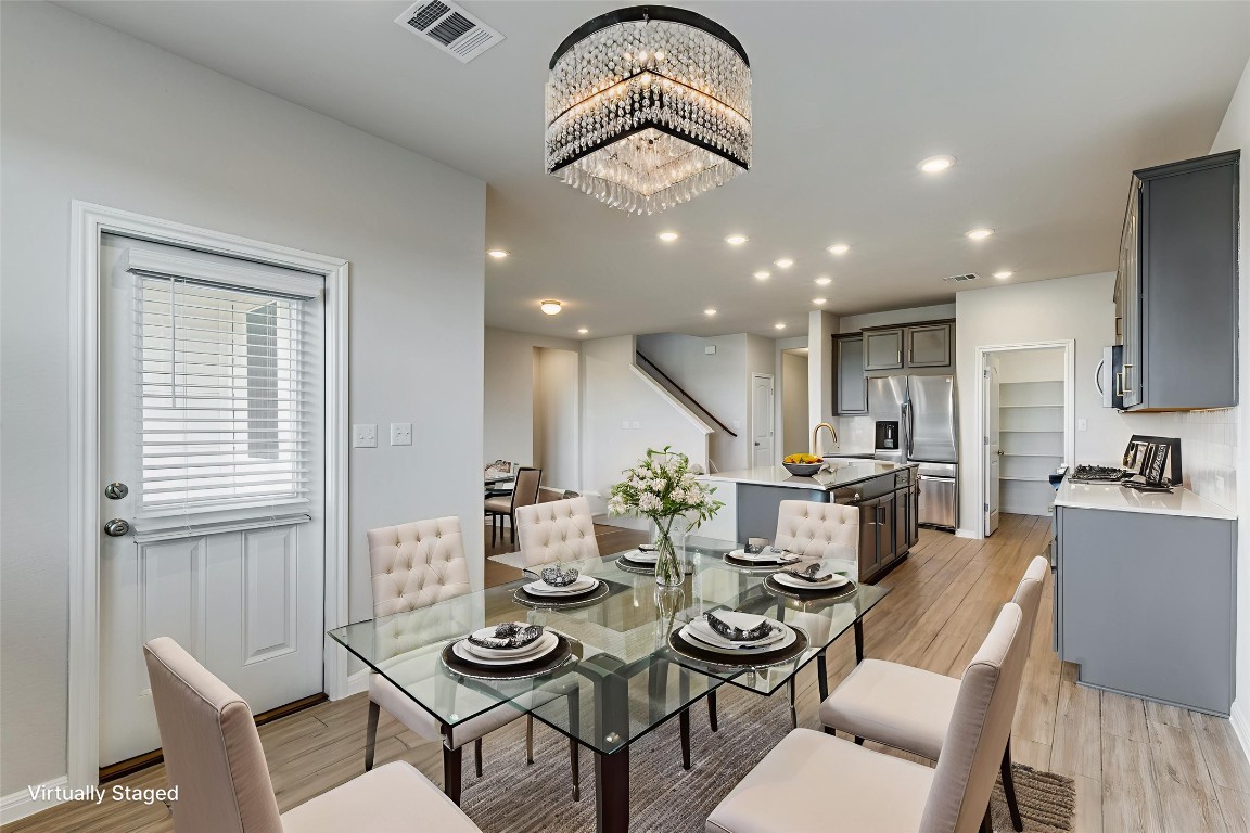 12912 Cerro Castellan Trace Manor, TX 78653 - Photo 29 of 36 a view of a dining room with furniture window and wooden floor