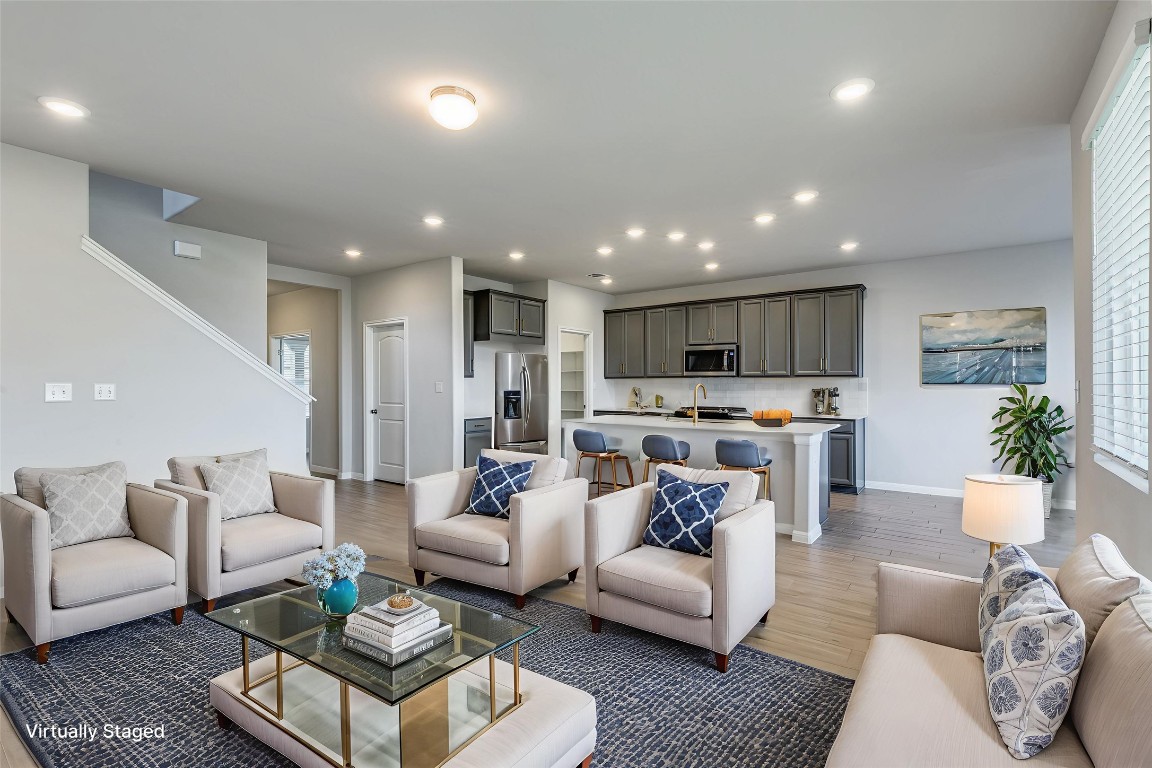 12912 Cerro Castellan Trace Manor, TX 78653 - Photo 3 of 36 a living room with furniture and view of kitchen