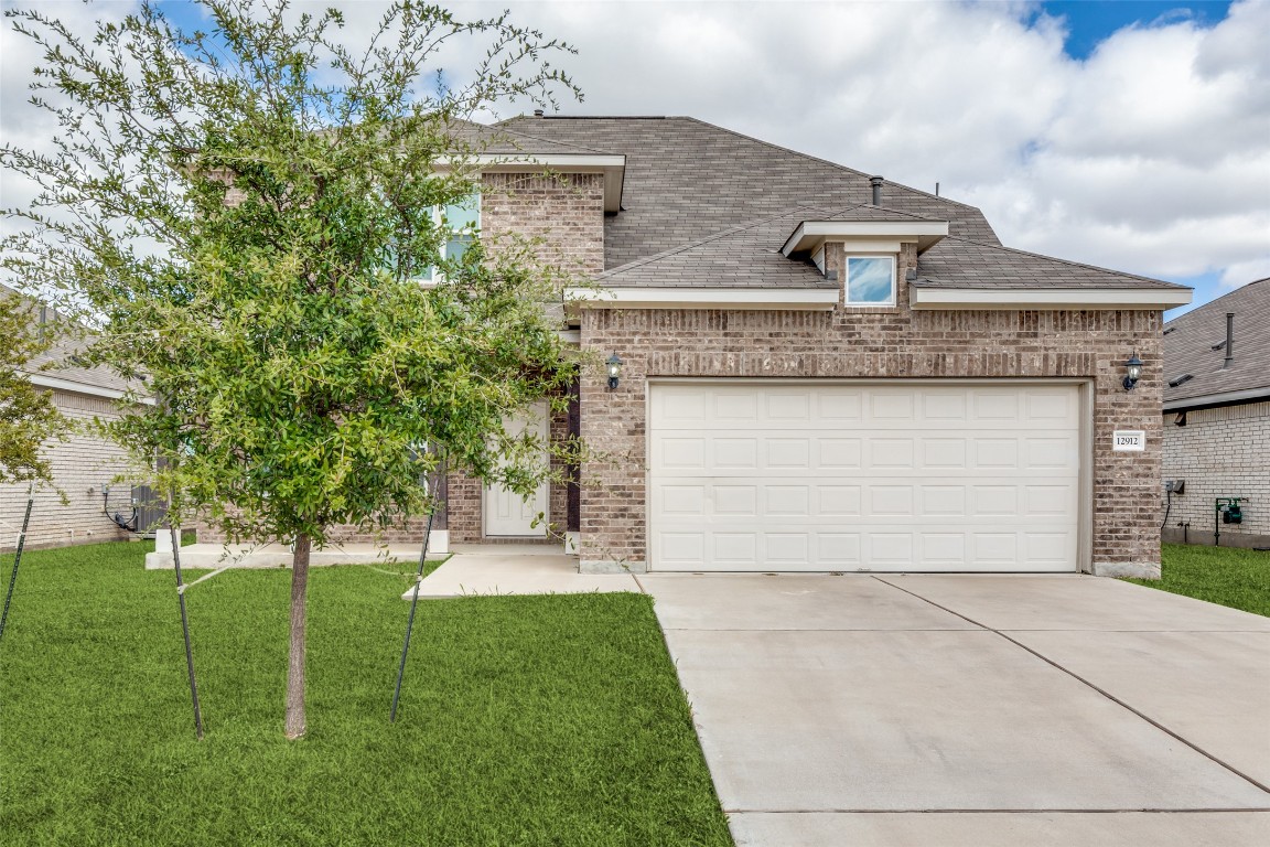 12912 Cerro Castellan Trace Manor, TX 78653 - Photo 36 of 36 a view of a house with a yard