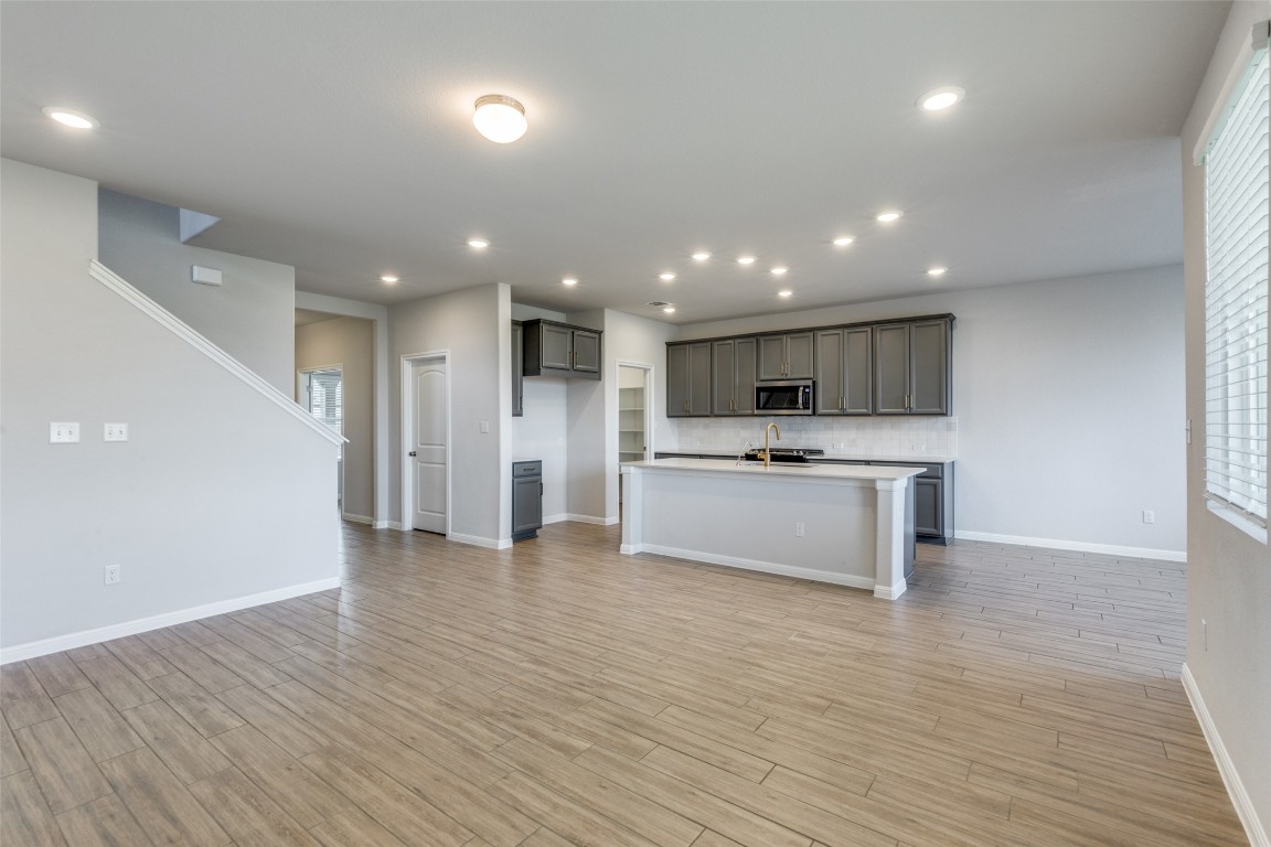 12912 Cerro Castellan Trace Manor, TX 78653 - Photo 4 of 36 a view of kitchen with refrigerator stove microwave and cabinets