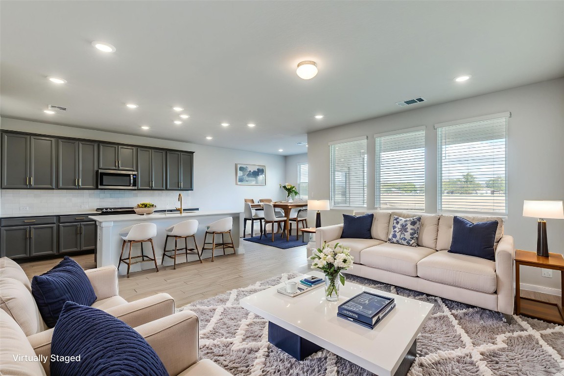 12912 Cerro Castellan Trace Manor, TX 78653 - Photo 5 of 36 a living room with furniture and view of kitchen