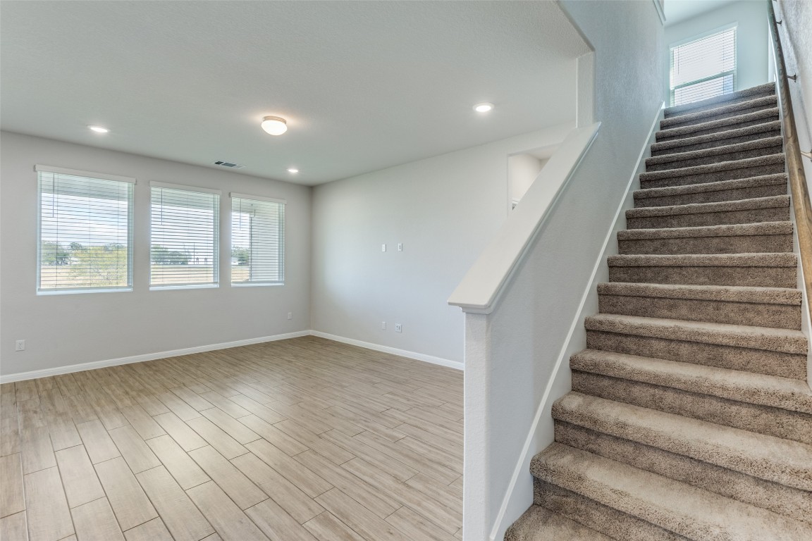 12912 Cerro Castellan Trace Manor, TX 78653 - Photo 8 of 36 an empty room with wooden floor and windows