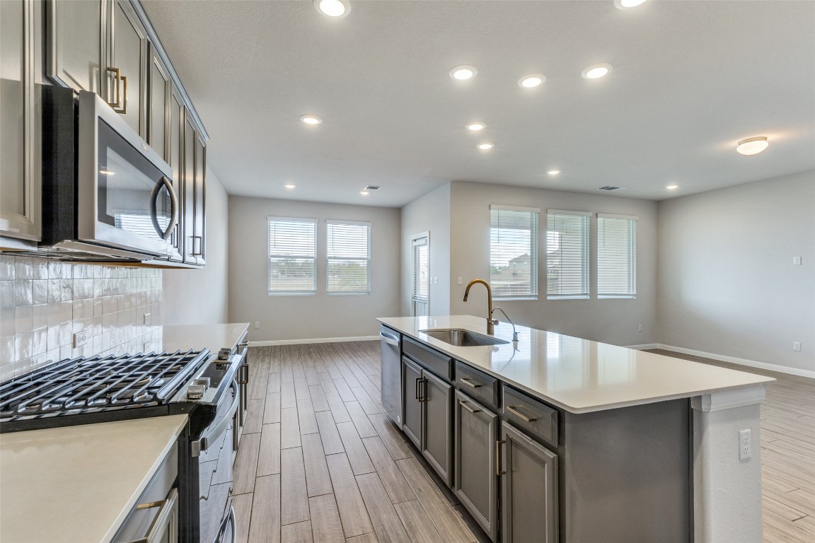 12912 Cerro Castellan Trace Manor, TX 78653 - Photo 10 of 36 a kitchen with sink microwave and stove