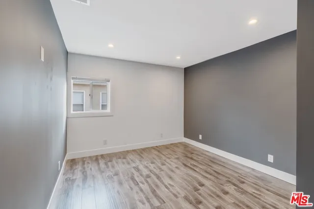 a bedroom with a bed and a potted plant