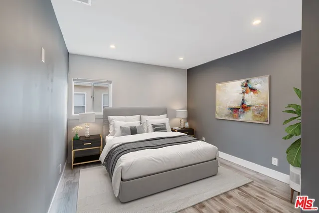 an empty room with wooden floor and closet