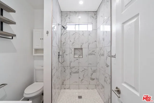a view of empty room with wooden floor and closet