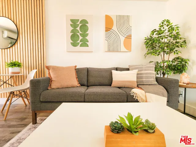 a large bed in a bedroom next to a window