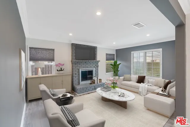 a view of a kitchen with wooden floor electronic appliances and windows