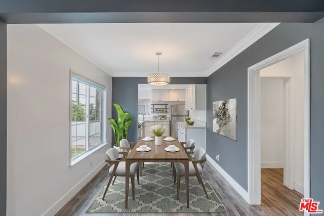 a view of a kitchen with a window and wooden floor