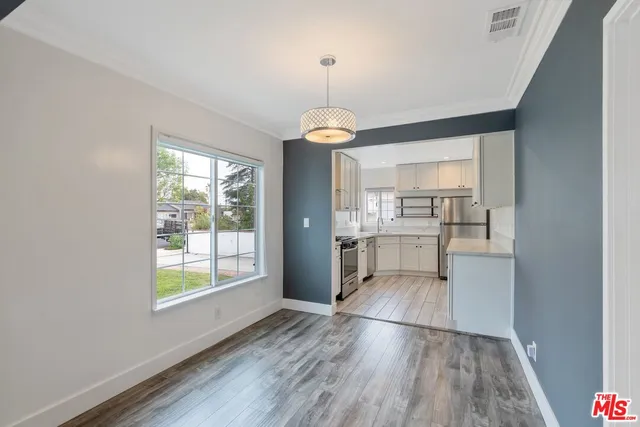 a kitchen with white cabinets stainless steel appliances and sink